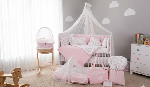 Soft nursery corner with an ElmaLella baby nest, gentle pastel textiles and warm wooden details