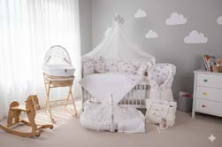 ElmaLella baby essentials arranged in a warm nursery corner